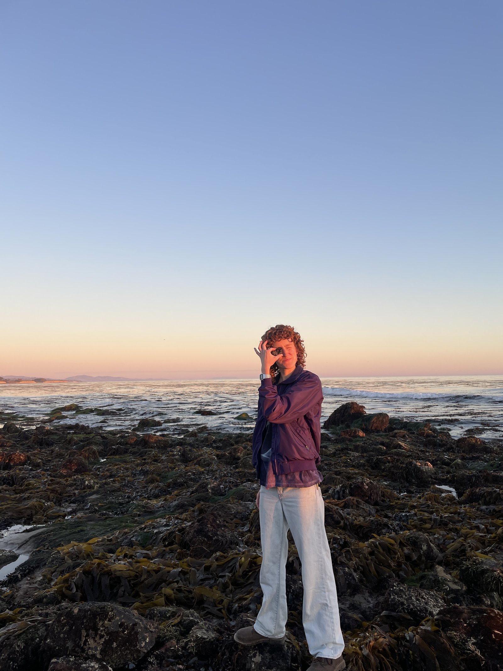 Kathryn McMahon exploring tide pools on the Santa Barbara coast at sunset